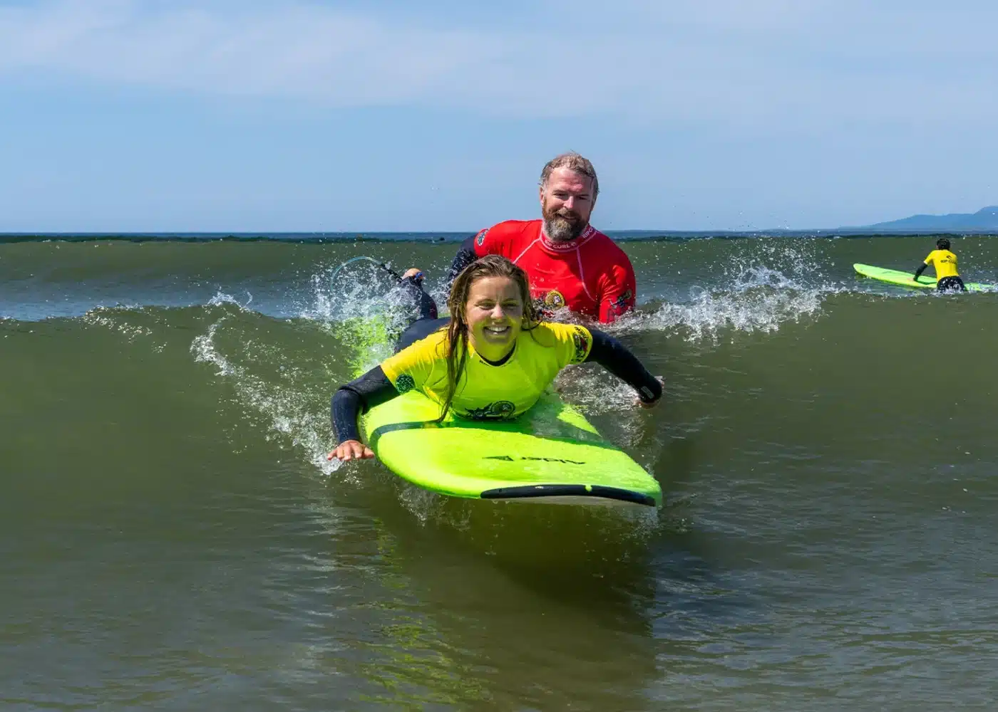 Neil helping student surf