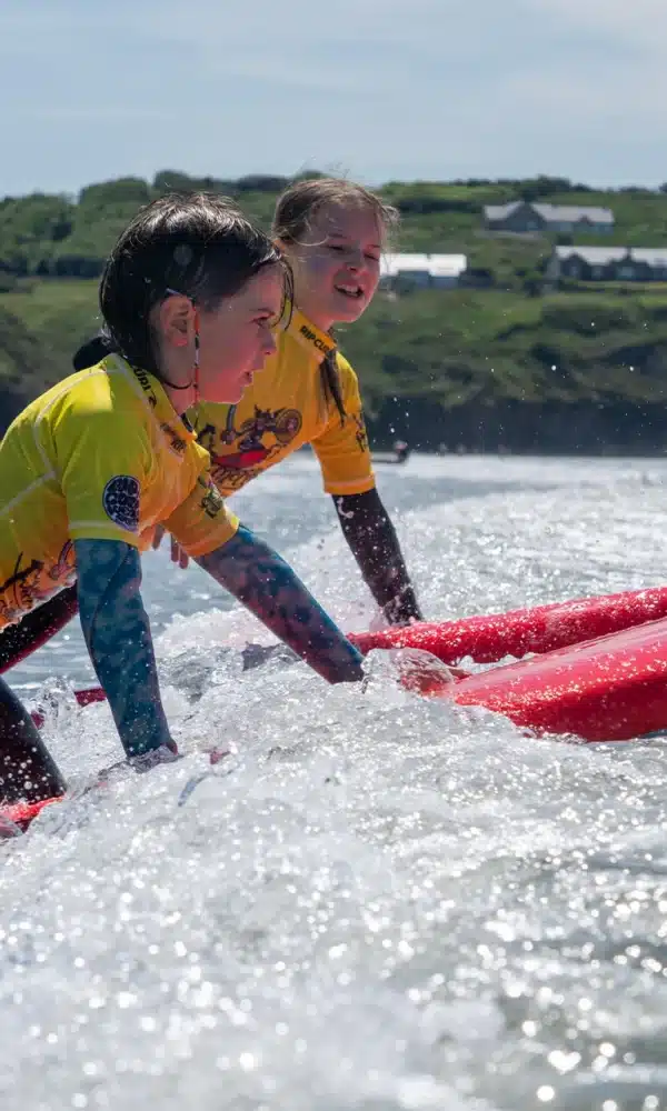 Two kids surfing